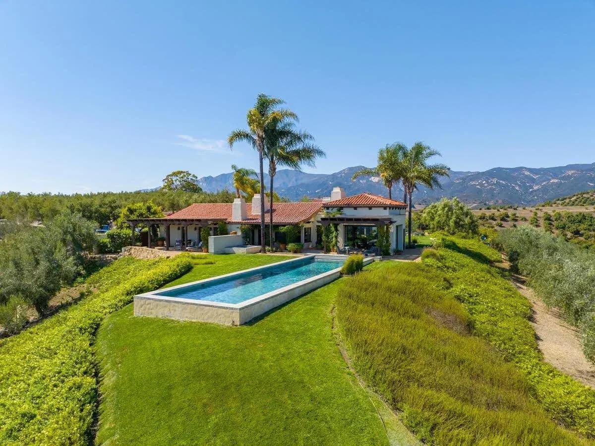 Aerial view of a hillside villa and pool wired by Godfrey Electric