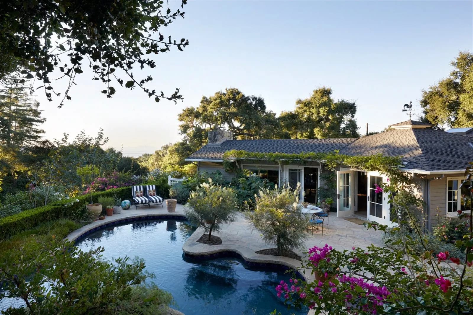 Poolside exterior of a Ladera Lane residence at dusk